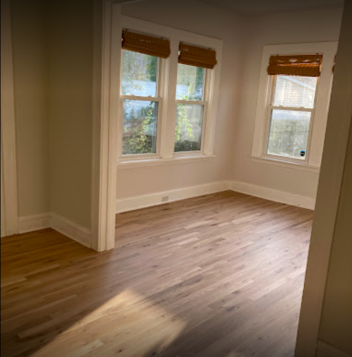 photo shows a sunny room with restored hardwood flooring in cleveland