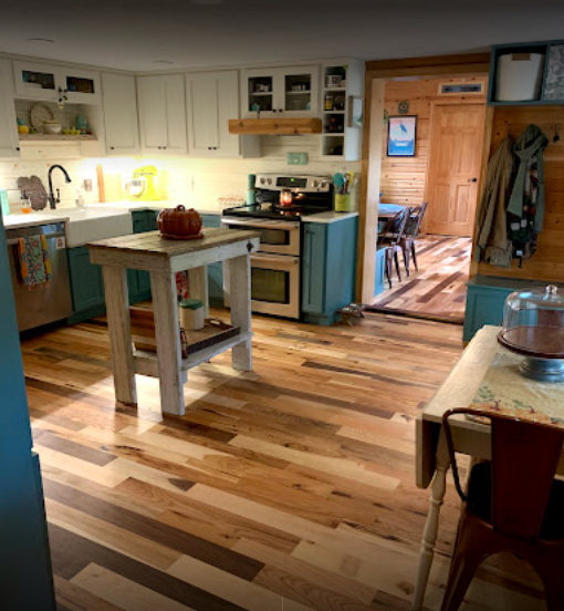 photo shows a kitchen with colorful cabinets and restored hardwood flooring in cleveland