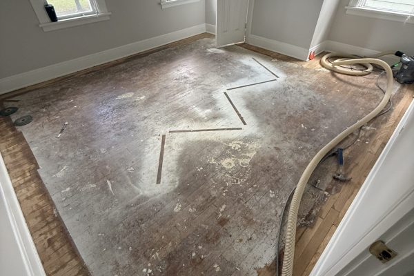 photo shows the before of a recently refinished hardwood floor in cleveland, ohio